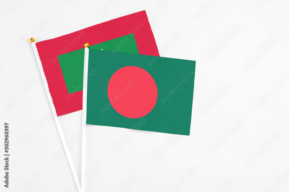 Bangladesh and Maldives stick flags on white background. High quality fabric, miniature national flag. Peaceful global concept.White floor for copy space. Bangladesh and Maldives stick flags on white background. High quality fabric, miniature national flag. Peaceful global concept.White floor for copy space.