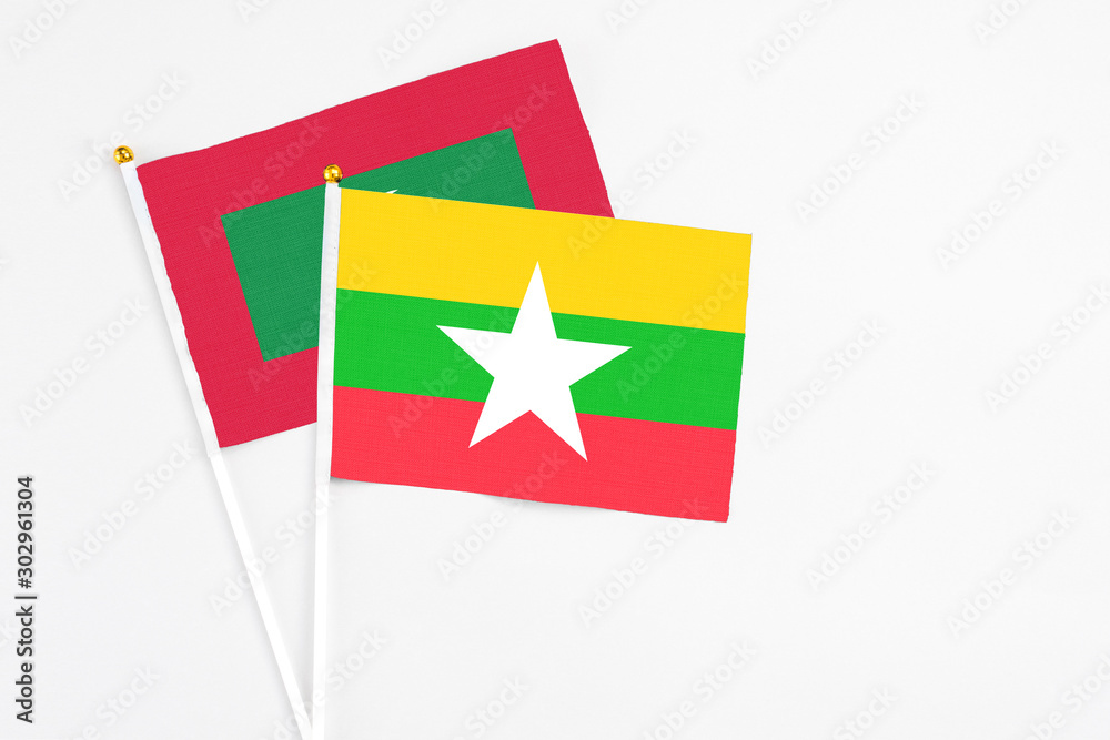 Myanmar and Maldives stick flags on white background. High quality fabric, miniature national flag. Peaceful global concept.White floor for copy space. Myanmar and Maldives stick flags on white background. High quality fabric, miniature national flag. Peaceful global concept.White floor for copy space.