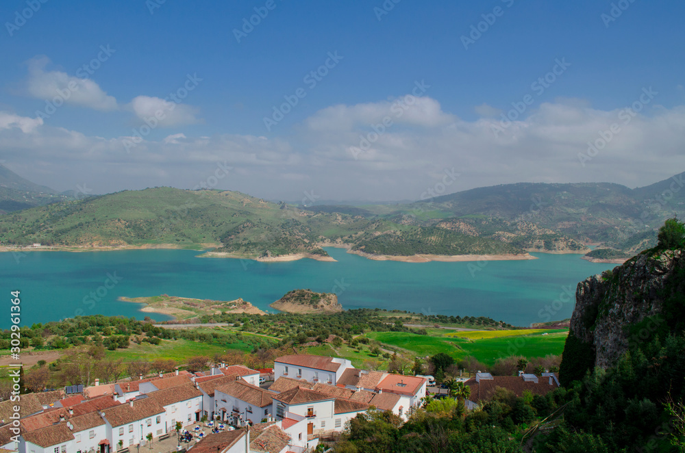 View of the lake of Zahara de la Sierra and its white village. Whitewashed walls and red or brown tiled roofs. Cadiz, Andalusia, Spain