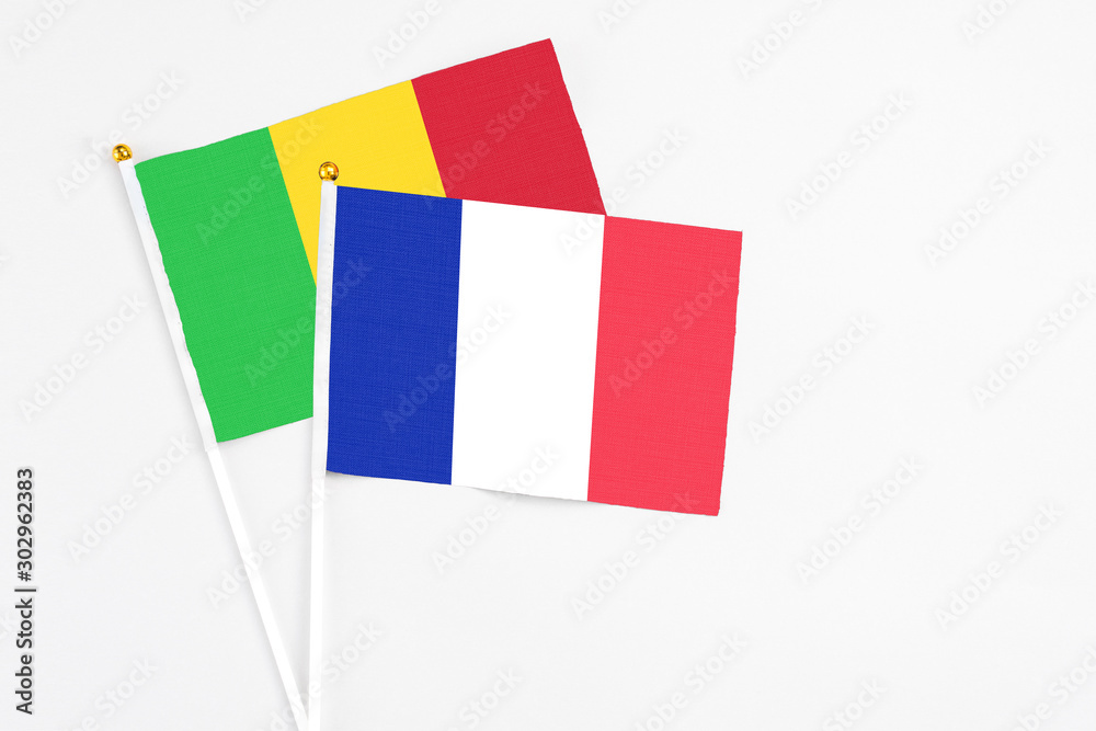 France and Mali stick flags on white background. High quality fabric, miniature national flag. Peaceful global concept.White floor for copy space. France and Mali stick flags on white background. High quality fabric, miniature national flag. Peaceful global concept.White floor for copy space.