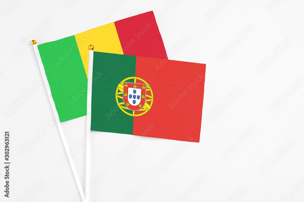 Portugal and Mali stick flags on white background. High quality fabric, miniature national flag. Peaceful global concept.White floor for copy space. Portugal and Mali stick flags on white background. High quality fabric, miniature national flag. Peaceful global concept.White floor for copy space.