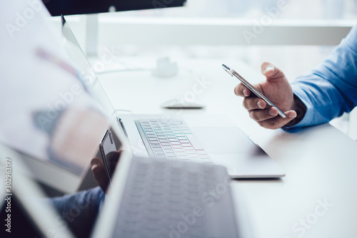 Crop businessman using mobile phone