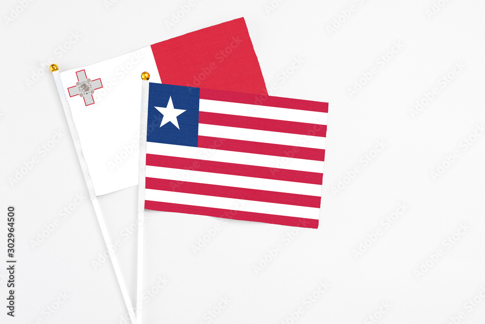 Liberia and Malta stick flags on white background. High quality fabric, miniature national flag. Peaceful global concept.White floor for copy space. Liberia and Malta stick flags on white background. High quality fabric, miniature national flag. Peaceful global concept.White floor for copy space.