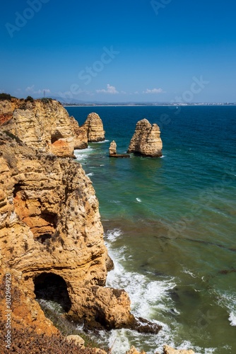 Coastal cliffs and sea stacks near Ponta da Piedate, Lagos, Portugal.