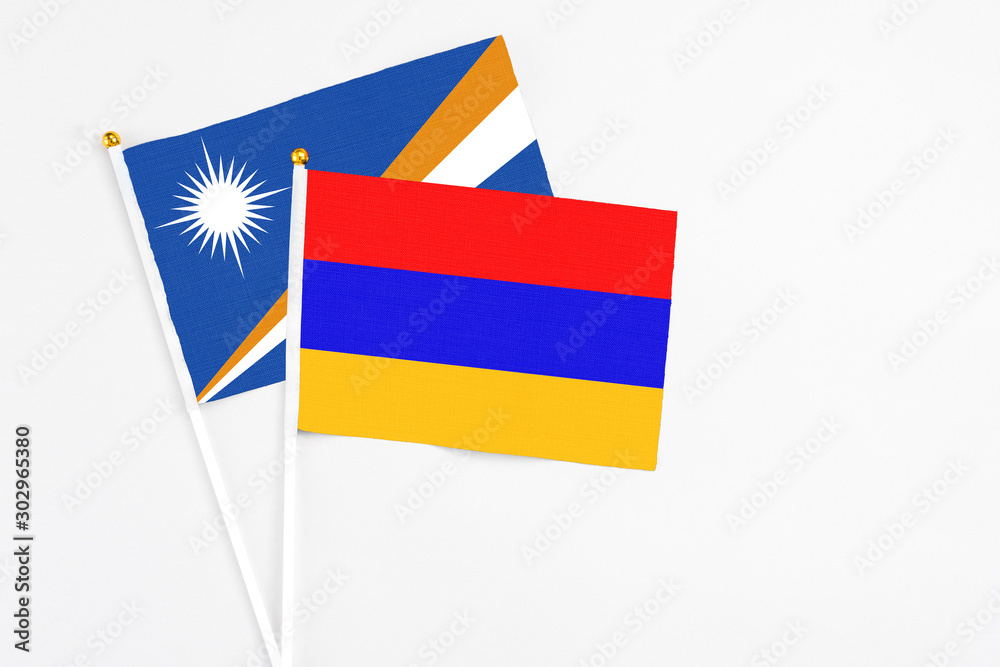 Armenia and Marshall Islands stick flags on white background. High quality fabric, miniature national flag. Peaceful global concept.White floor for copy space. Armenia and Marshall Islands stick flags on white background. High quality fabric, miniature national flag. Peaceful global concept.White floor for copy space.