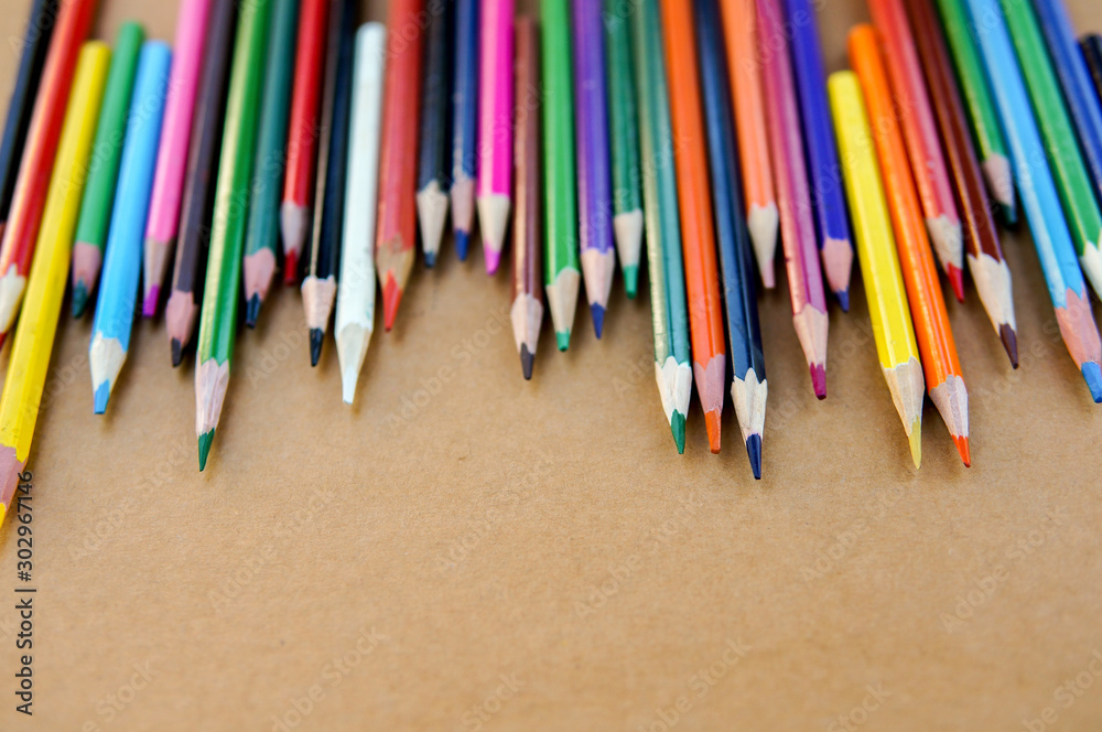 Multicolor sharpened pencils isolated on paper background in a row and messy Multicolor sharpened pencils isolated on paper background in a row and messy