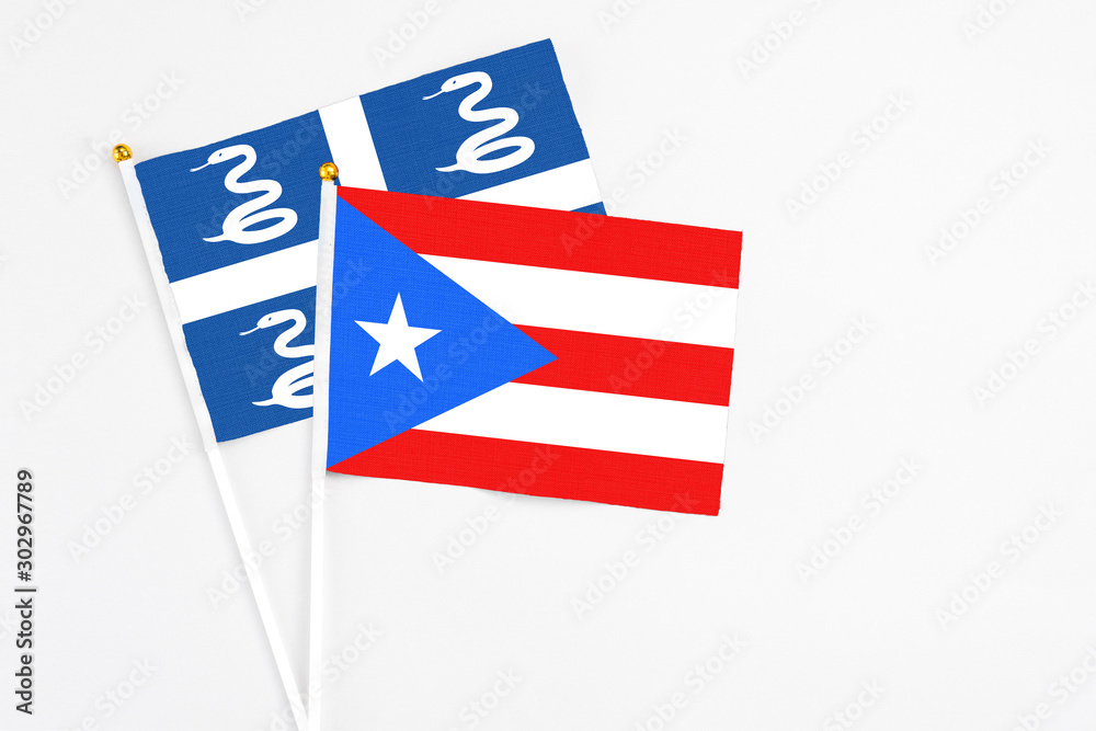 Puerto Rico and Martinique stick flags on white background. High quality fabric, miniature national flag. Peaceful global concept.White floor for copy space. Puerto Rico and Martinique stick flags on white background. High quality fabric, miniature national flag. Peaceful global concept.White floor for copy space.