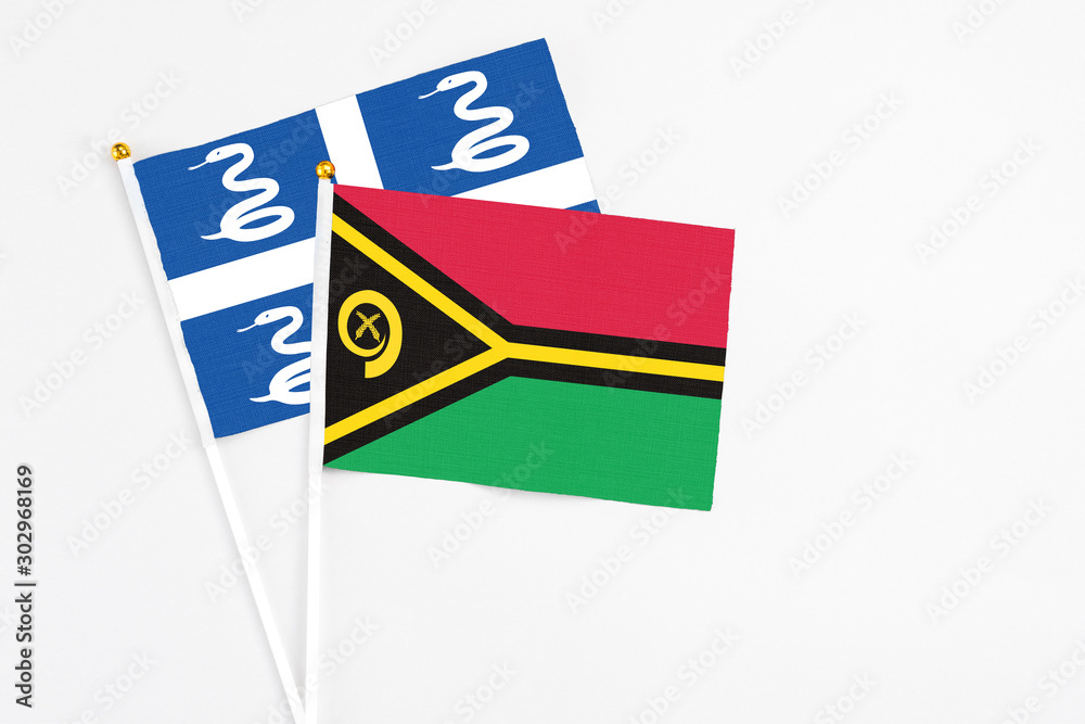 Vanuatu and Martinique stick flags on white background. High quality fabric, miniature national flag. Peaceful global concept.White floor for copy space.