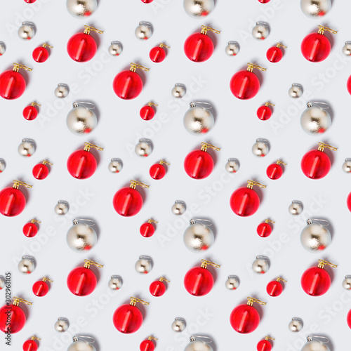 Fototapeta Naklejka Na Ścianę i Meble -  Merry Christmas and New Year seamless pattern. rhythmic ornament of silver and red shiny balls of Christmas decorations. Packaging concept, background, ornament