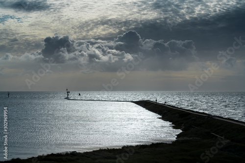 Imposing cloud formations above the pier of West Terschelling . photo