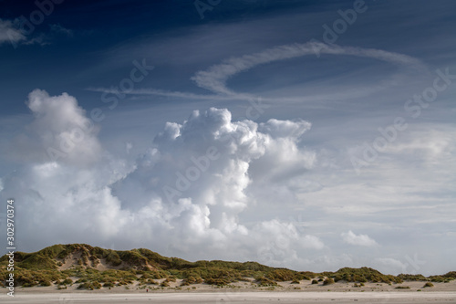 Cloud formations over the dunes on the island of Terschelling .