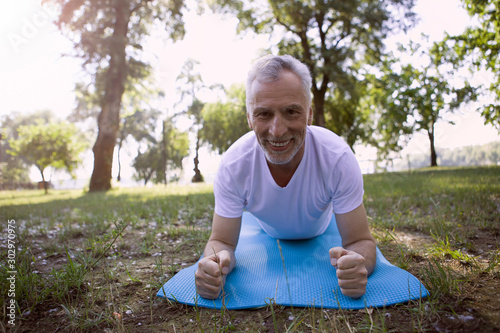 Gladsome man practicing arm exercises stock photo photo