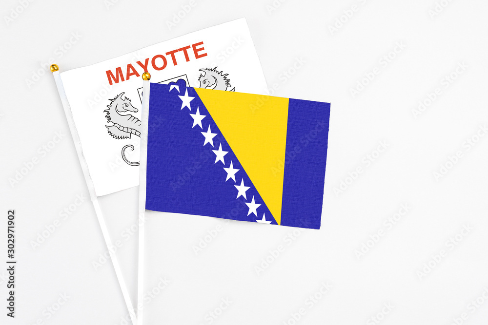 Bosnia Herzegovina and Mayotte stick flags on white background. High quality fabric, miniature national flag. Peaceful global concept.White floor for copy space. Bosnia Herzegovina and Mayotte stick flags on white background. High quality fabric, miniature national flag. Peaceful global concept.White floor for copy space.