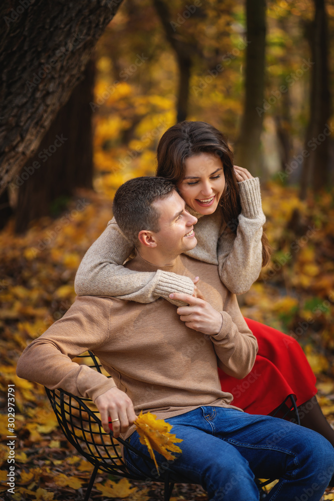 Fototapeta premium Young couple having fun in the autumn park