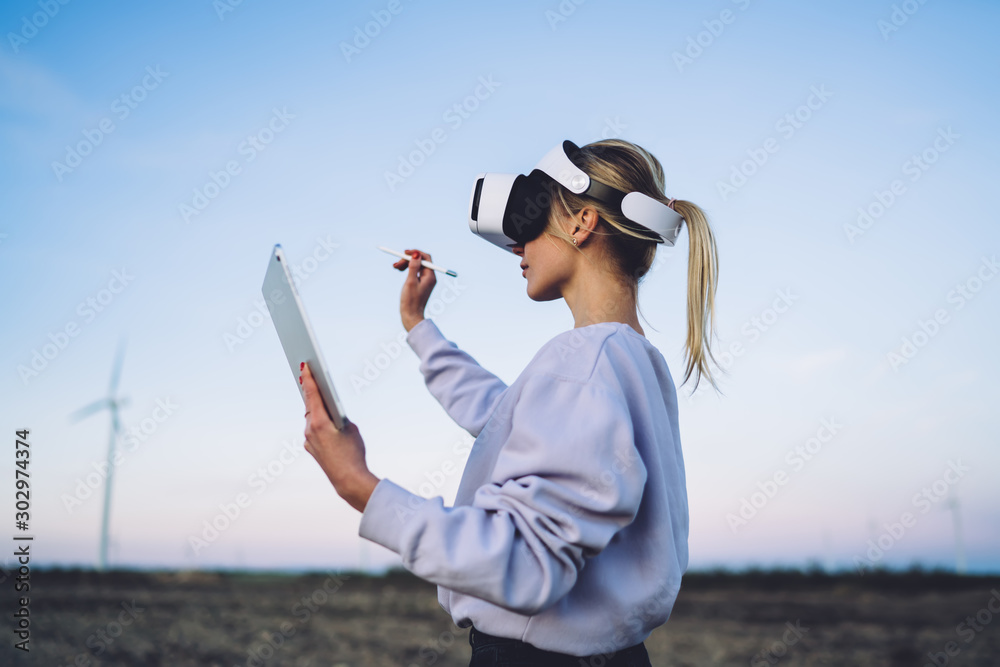 Lady creating digital virtual reality in field