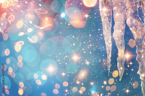 Fototapeta Naklejka Na Ścianę i Meble -  Christmas and New Year holidays background with icicle. Glitter lights backdrop. Winter season. Text space. Closeup of icicle. Elements of this Image Furnished by NASA.