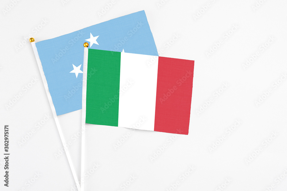 Italy and Micronesia stick flags on white background. High quality fabric, miniature national flag. Peaceful global concept.White floor for copy space. Italy and Micronesia stick flags on white background. High quality fabric, miniature national flag. Peaceful global concept.White floor for copy space.