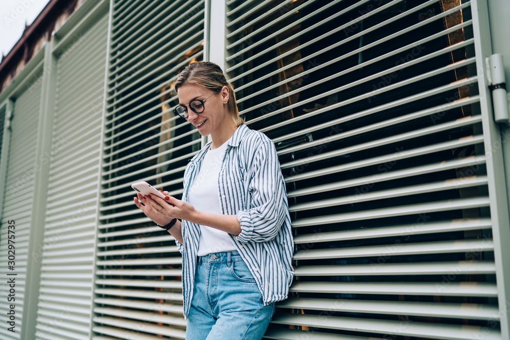 Cheerful woman smiling while doing videocall Cheerful woman smiling while doing videocall