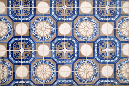 Wall with traditional Portuguese decor tiles azulezhu in blue tones.