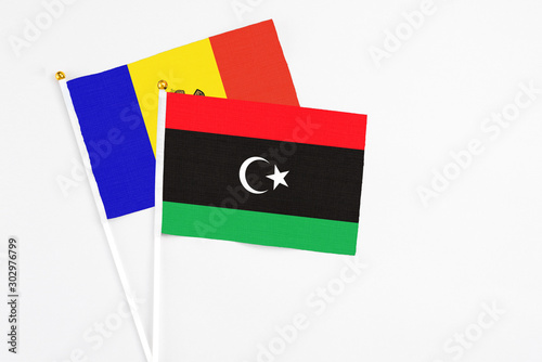 Libya and Moldova stick flags on white background. High quality fabric, miniature national flag. Peaceful global concept.White floor for copy space.