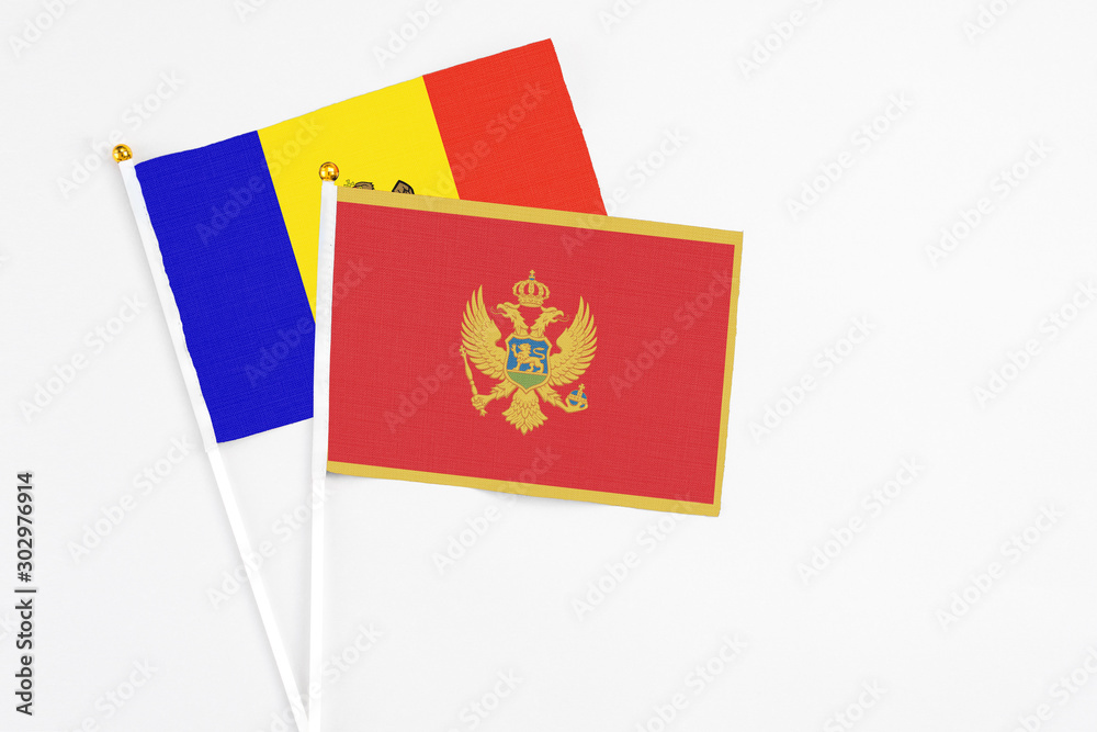 Montenegro and Moldova stick flags on white background. High quality fabric, miniature national flag. Peaceful global concept.White floor for copy space.