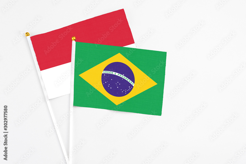 Brazil and Monaco stick flags on white background. High quality fabric, miniature national flag. Peaceful global concept.White floor for copy space.