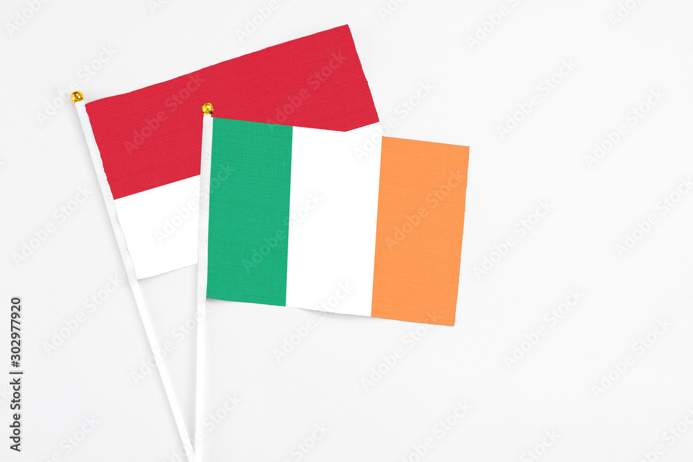 Ireland and Monaco stick flags on white background. High quality fabric, miniature national flag. Peaceful global concept.White floor for copy space. Ireland and Monaco stick flags on white background. High quality fabric, miniature national flag. Peaceful global concept.White floor for copy space.