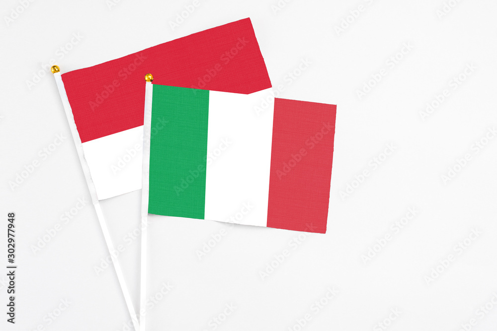 Italy and Monaco stick flags on white background. High quality fabric, miniature national flag. Peaceful global concept.White floor for copy space. Italy and Monaco stick flags on white background. High quality fabric, miniature national flag. Peaceful global concept.White floor for copy space.