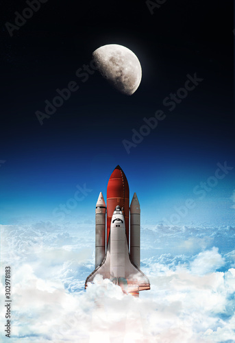 Space shuttle launch in outer space from Earth. Moon on background, Rocket on orbit of the planet. Border of blue sky with clouds and dark deep space. .Elements of this image furnished by NASA 