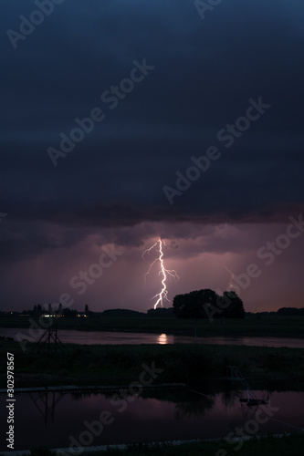 Lightning bolt hitting the ground close to a river