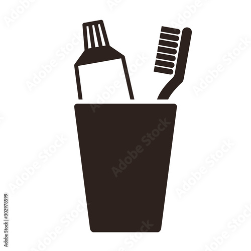 Toothpaste and toothbrush in cup