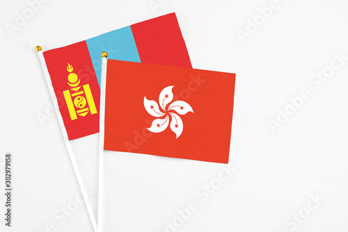 Hong Kong and Mongolia stick flags on white background. High quality fabric, miniature national flag. Peaceful global concept.White floor for copy space.