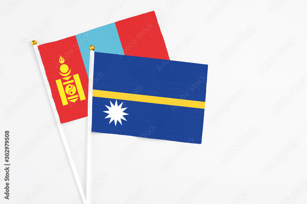 Nauru and Mongolia stick flags on white background. High quality fabric, miniature national flag. Peaceful global concept.White floor for copy space. Nauru and Mongolia stick flags on white background. High quality fabric, miniature national flag. Peaceful global concept.White floor for copy space.