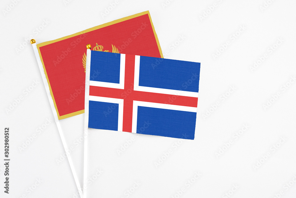 Iceland and Montenegro stick flags on white background. High quality fabric, miniature national flag. Peaceful global concept.White floor for copy space.