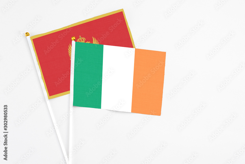 Ireland and Montenegro stick flags on white background. High quality fabric, miniature national flag. Peaceful global concept.White floor for copy space. Ireland and Montenegro stick flags on white background. High quality fabric, miniature national flag. Peaceful global concept.White floor for copy space.