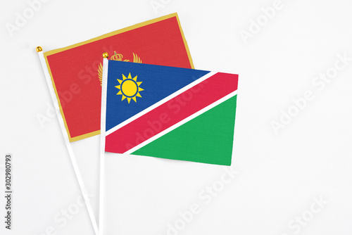 Free Download Namibia and Montenegro stick flags on white background. High quality fabric, miniature national flag. Peaceful global concept.White floor for copy space. - GFXLoad