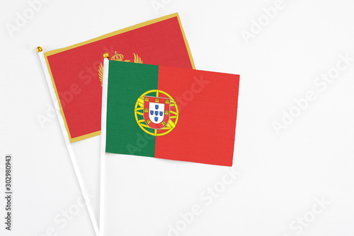 Portugal and Montenegro stick flags on white background. High quality fabric, miniature national flag. Peaceful global concept.White floor for copy space. Free Download Portugal and Montenegro stick flags on white background. High quality fabric, miniature national flag. Peaceful global concept.White floor for copy space. - GFXLoad