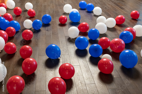 Colorful balloons on wooden floor of sports hall photo