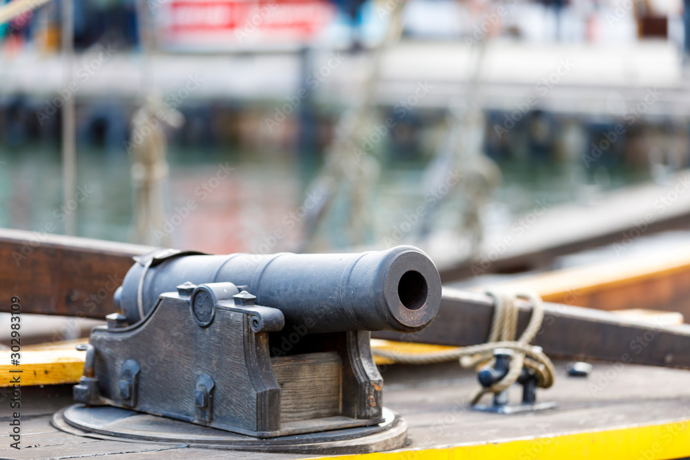 Ancient cannon on an old wooden yacht Ancient cannon on an old wooden yacht