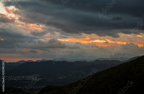 dramatic sunset with storm approching in mountains of dominican republic photo