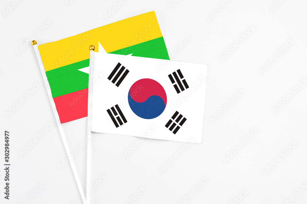 South Korea and Myanmar stick flags on white background. High quality fabric, miniature national flag. Peaceful global concept.White floor for copy space.