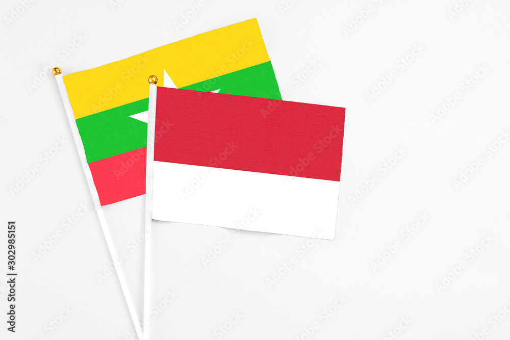 Monaco and Myanmar stick flags on white background. High quality fabric, miniature national flag. Peaceful global concept.White floor for copy space. Monaco and Myanmar stick flags on white background. High quality fabric, miniature national flag. Peaceful global concept.White floor for copy space.