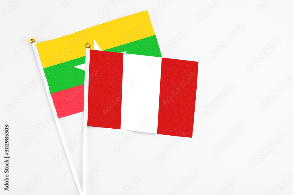 Peru and Myanmar stick flags on white background. High quality fabric, miniature national flag. Peaceful global concept.White floor for copy space. Peru and Myanmar stick flags on white background. High quality fabric, miniature national flag. Peaceful global concept.White floor for copy space.