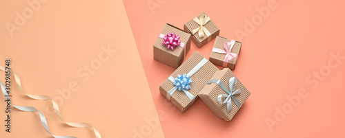 Valentines Day. Gift boxes, ribbon pastel set. Minimal. Creative art fashion greeting card. Flat lay. Presents on design coral beige color. Holiday gift shopping sale fashionable concept, banner