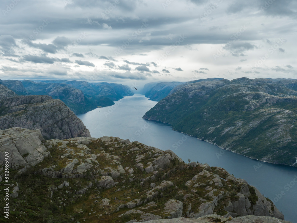 View on fjord Lysefjord, next to Preikestolen massive cliff famous Norway viewpoint Moody sky, autumn day. Nature and travel background, vacation and hiking holiday concept.