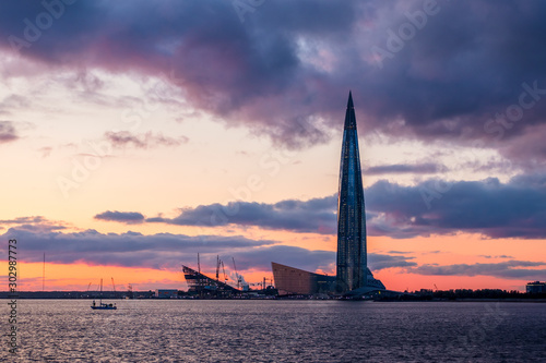 Sunset landscape with a skyscraper on the shore of the Baltic Sea. The tallest building in Europe. Modern architecture of St. Petersburg, Russia.