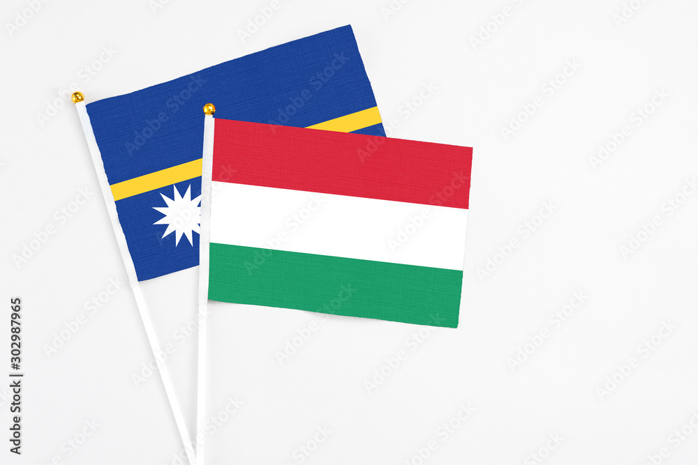 Hungary and Nauru stick flags on white background. High quality fabric, miniature national flag. Peaceful global concept.White floor for copy space. Hungary and Nauru stick flags on white background. High quality fabric, miniature national flag. Peaceful global concept.White floor for copy space.