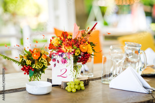 Beautiful autumn colored taable decoration for a special event. Fresh flower table decoration. photo