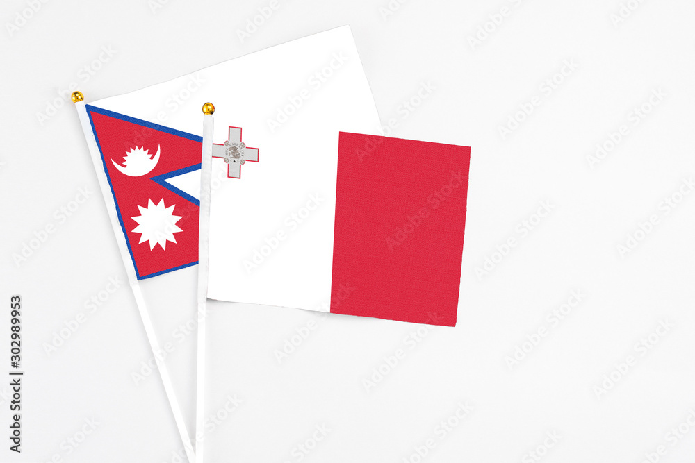 Malta and Nepal stick flags on white background. High quality fabric, miniature national flag. Peaceful global concept.White floor for copy space. Malta and Nepal stick flags on white background. High quality fabric, miniature national flag. Peaceful global concept.White floor for copy space.