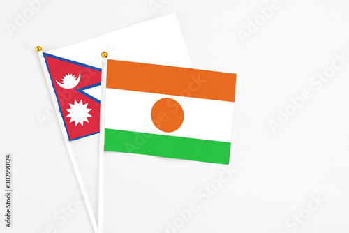 Niger and Nepal stick flags on white background. High quality fabric, miniature national flag. Peaceful global concept.White floor for copy space. Free Download Niger and Nepal stick flags on white background. High quality fabric, miniature national flag. Peaceful global concept.White floor for copy space. - GFXLoad